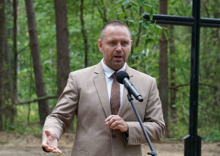 Karol Nawrocki speaking at a microphone