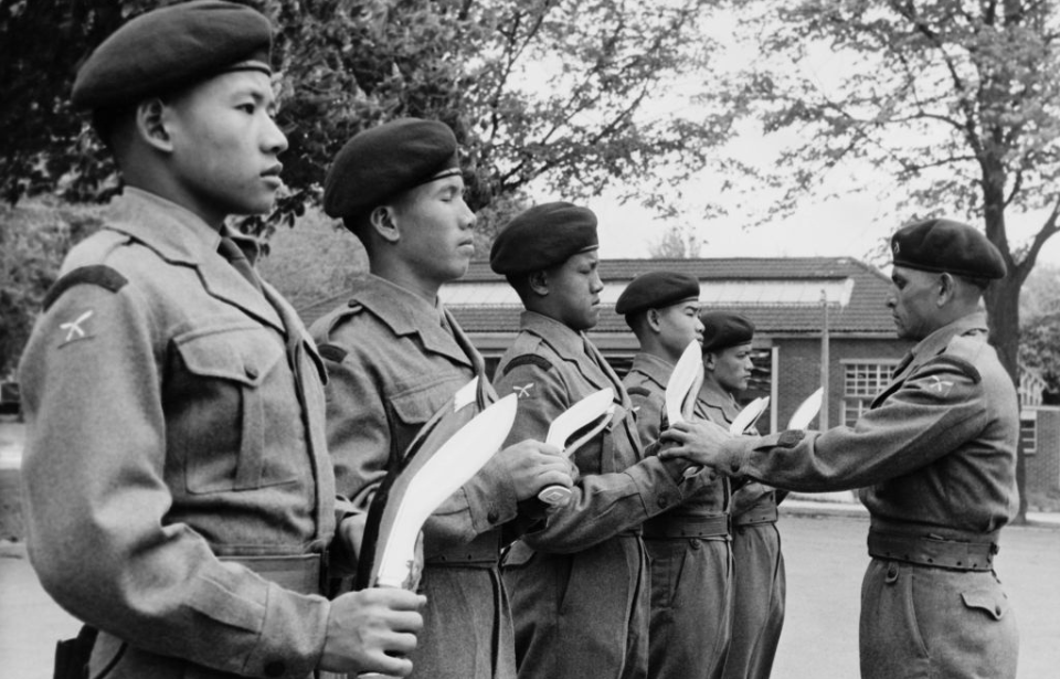 Gurkhas standing in a line with their Kukri blades