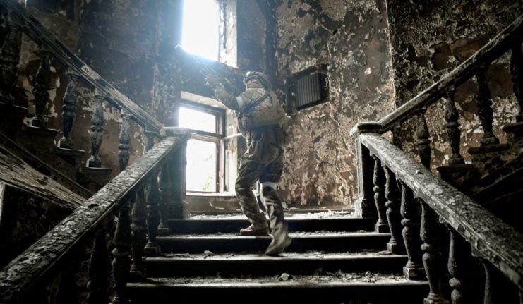 Russian soldier climbing up a flight of stairs