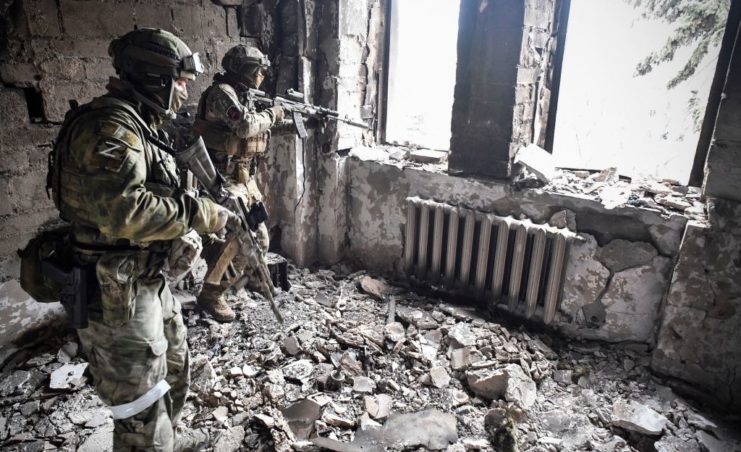 Two Russian soldiers looking out a window