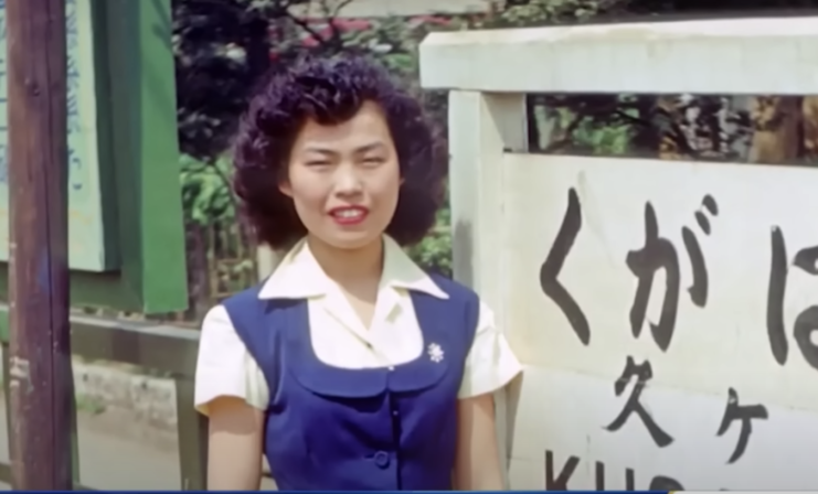 Peggy Yamaguchi standing in front of a sign