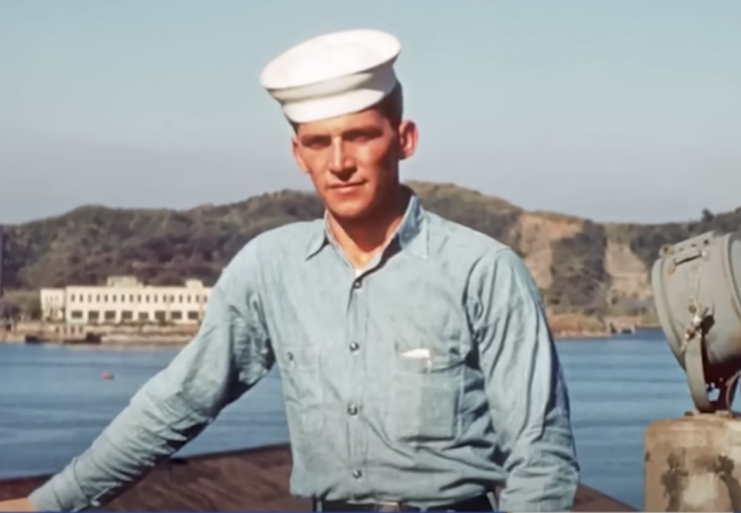 Duane Mann posing in front of a body of water