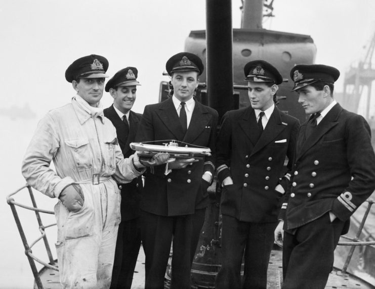Five British Royal Navy Officers standing on the deck of the HMS Seraph