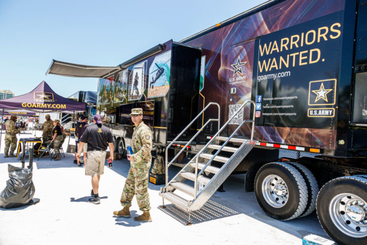 US Army recruiter standing outside a truck