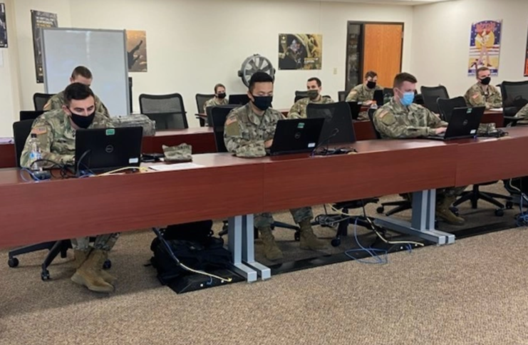 US Army soldiers sitting in front of computers