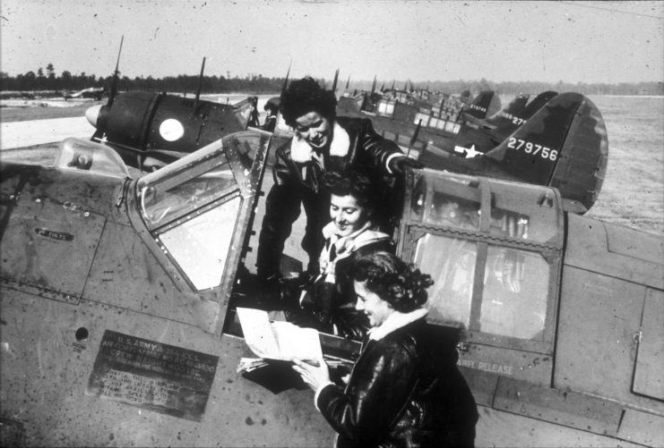 Dora Dougherty Strother standing around an aircraft with two other female pilots