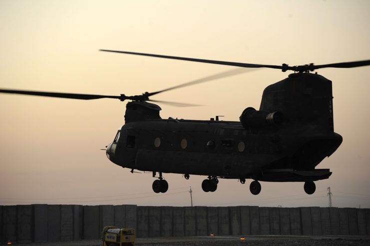 Boeing CH-47 Chinook helicopter taking off at dusk