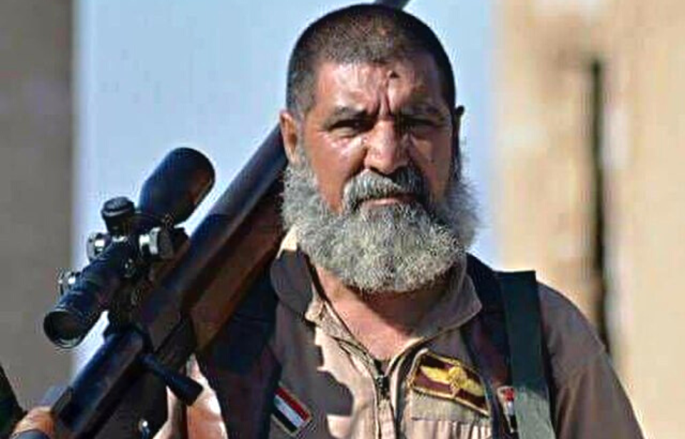 Abu Tahsin al-Salhi resting his rifle on his shoulder