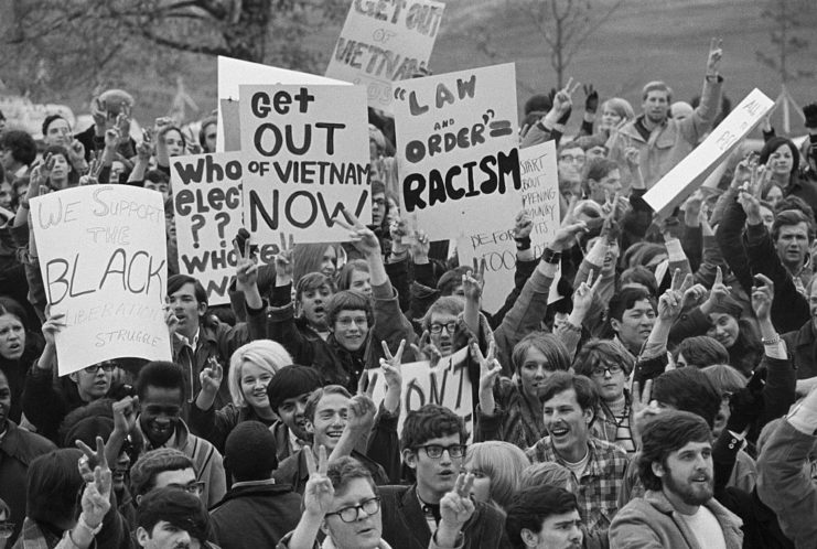 Group of anti-war protesters holding signs