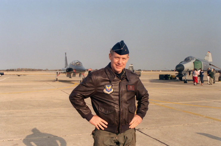 Richard Ritchie standing on a runway while wearing his pilot's jacket