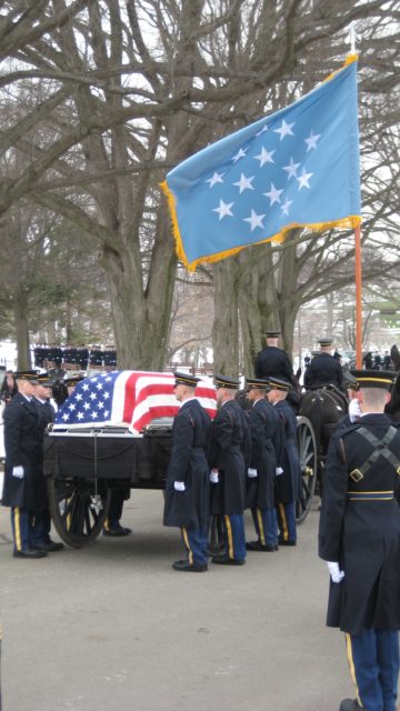 Old Guard caisson carrying a casket draped in the American flag