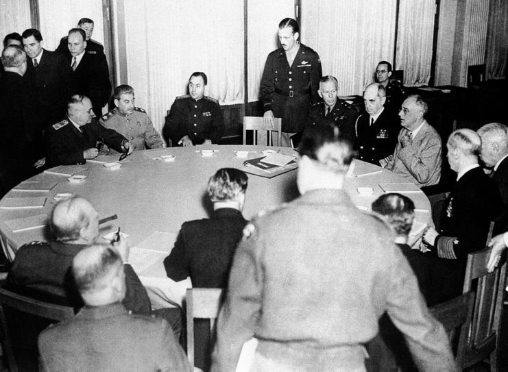 Joseph Stalin, Winston Churchill and Franklin D. Roosevelt sitting at a table with other government officials