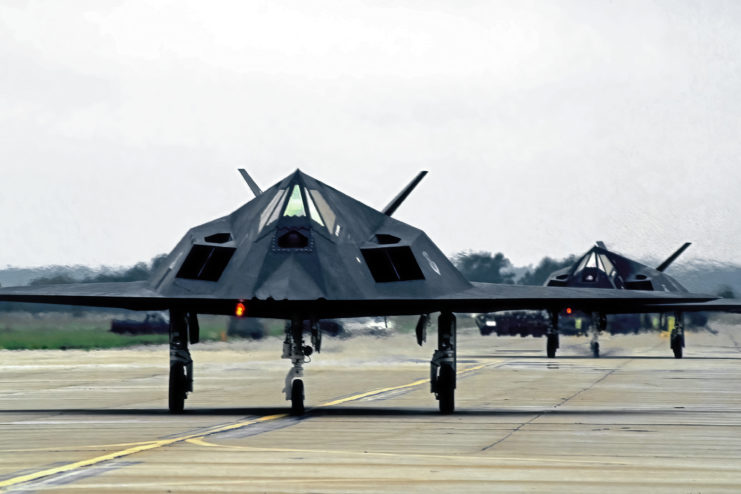 Two Lockheed F-117 Nighthawks lined up on a runway