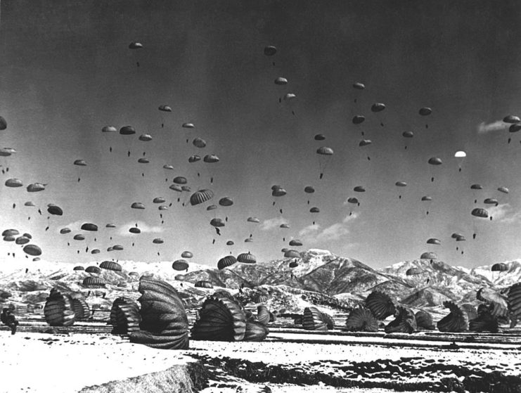 Parachutes landing over a large area of land