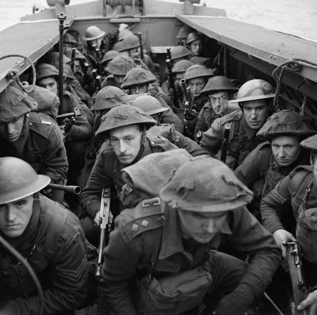 British troops ducking within a landing craft at sea