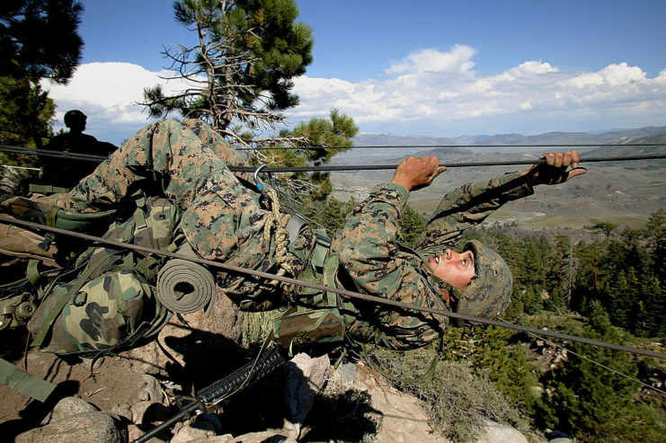 US Marine using a rope to cross a canyon