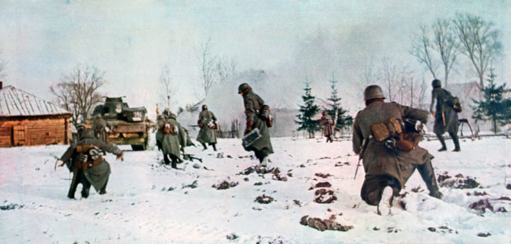 Tank leading a group of German soldiers through the snow