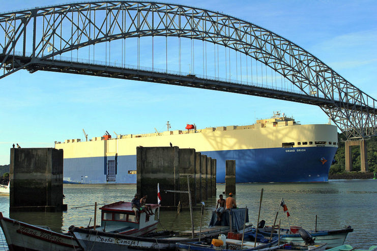 Container ship sailing beneath the Bridge of the Americas