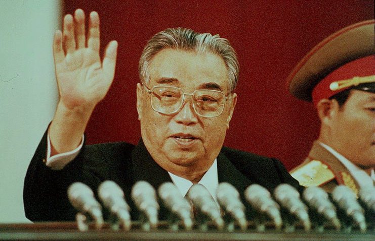 Kim Il-Sung waving from a podium