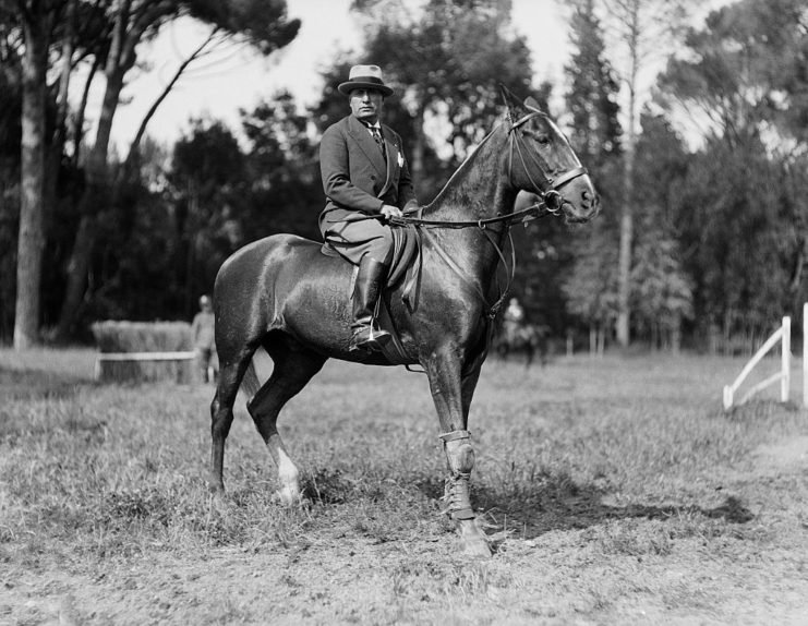 Benito Mussolini riding a horse
