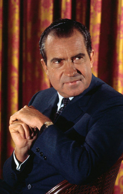 Richard Nixon sitting in a chair
