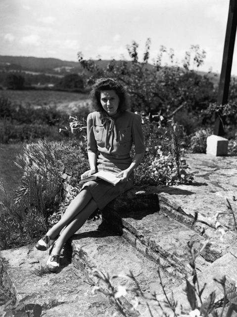 Odette Sansom sitting on stone steps