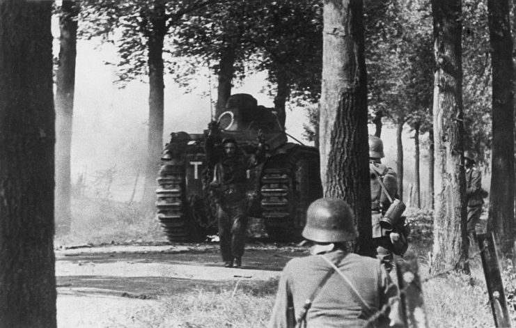 German soldiers approaching a French soldier standing in front of a Char B1