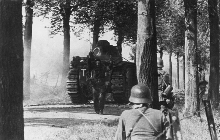 German soldiers approaching a French soldier standing in front of a Char B1