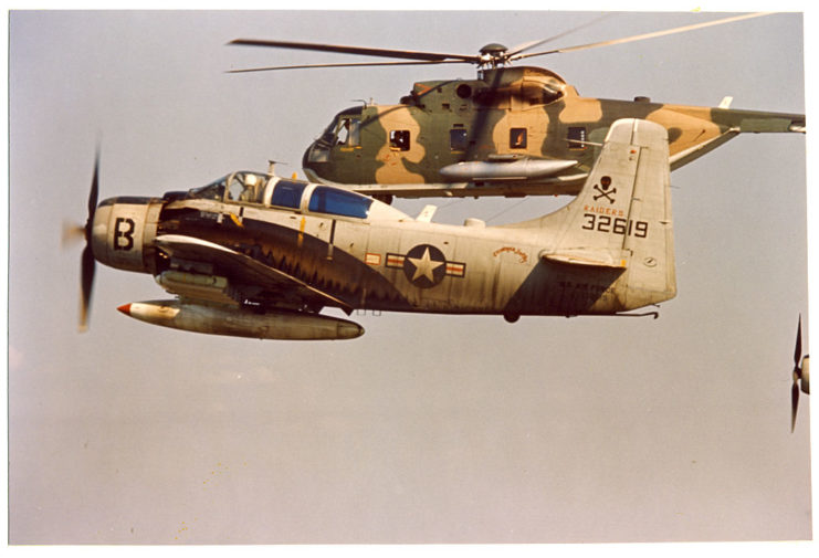 A Skyraider and Sikorsky CH-3C helicopter mid-flight during a rescue mission