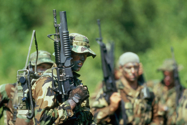 US Navy SEALs standing with firearms