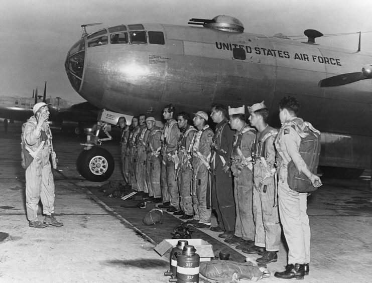 Boeing B-29 Superfortress crew standing in a line beside the aircraft