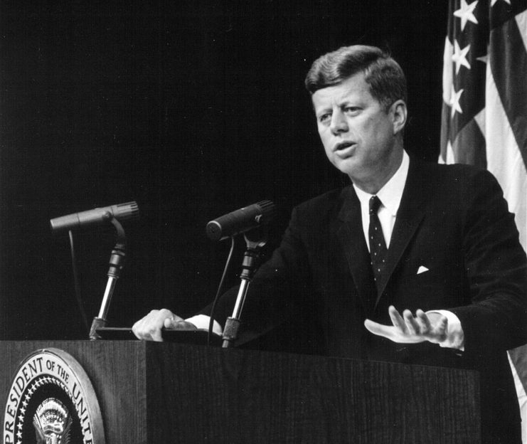 John F. Kennedy speaking at a podium