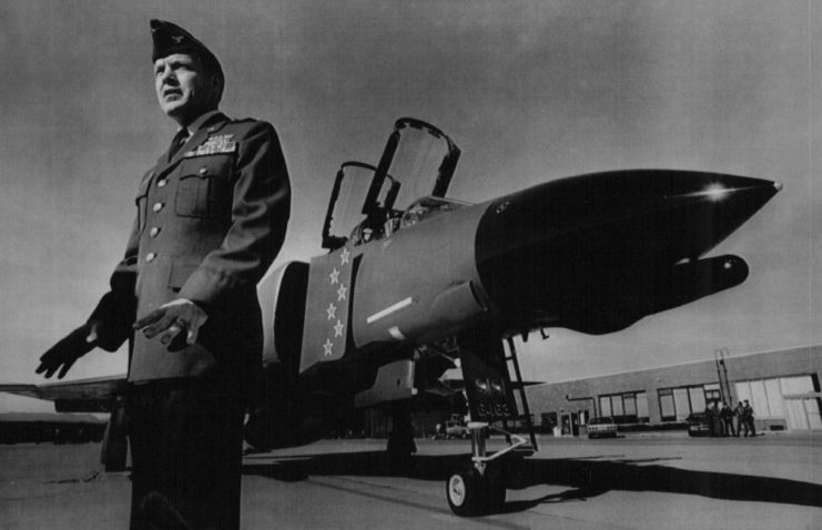 Richard Ritchie standing near a McDonnell Douglas F-4 Phantom II