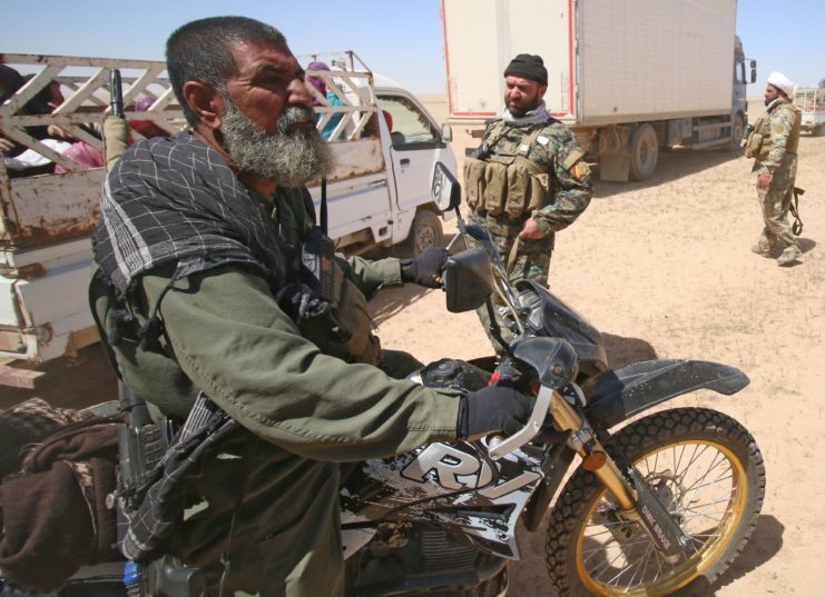 Abu Tahsin al-Salhi sitting on a motorcycle