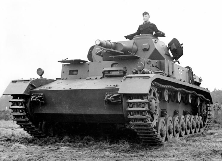 Soldier sticking out the top of a tank