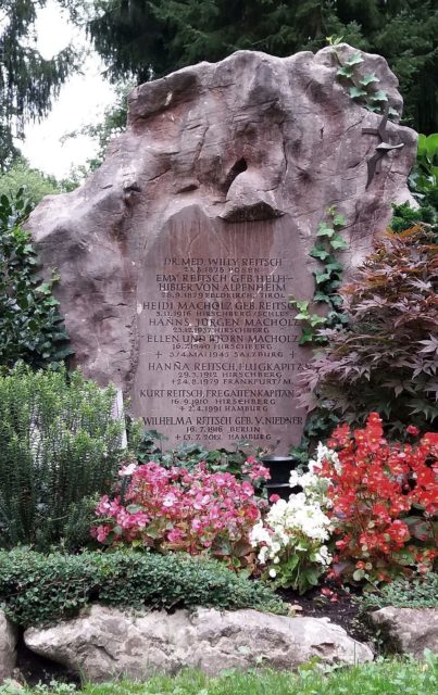 Hanna Reitsch's gravestone surrounded by flowers and greenery