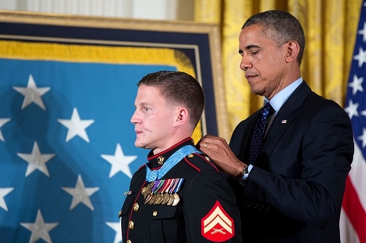 President Barack Obama placing the Medal of Honor around Kyle Carpenter's neck