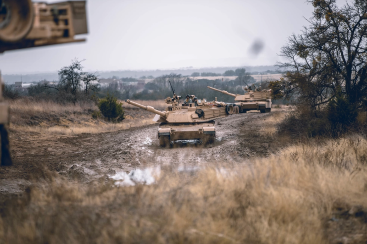 M1A2 SEPv3 Abrams driving down a muddy road