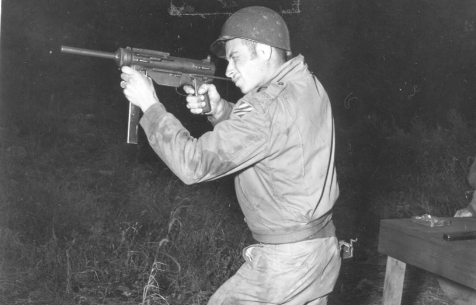 Infantryman aiming an M3 "Grease Gun"