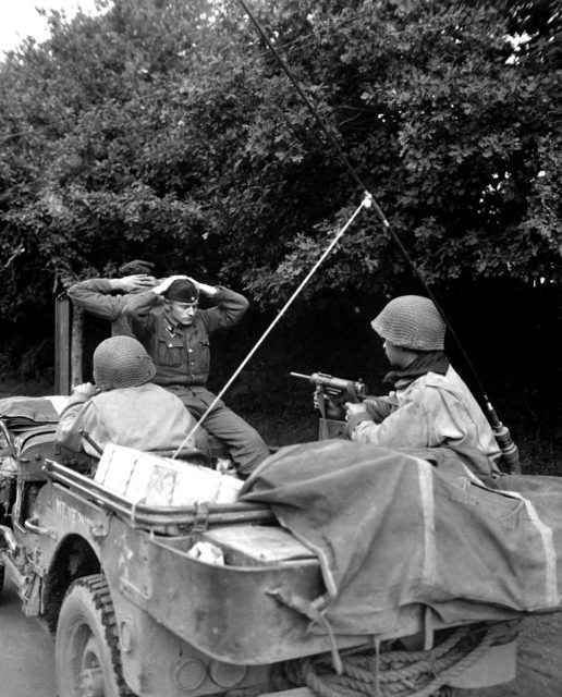 Soldier surrendering to two others sitting in a vehicle