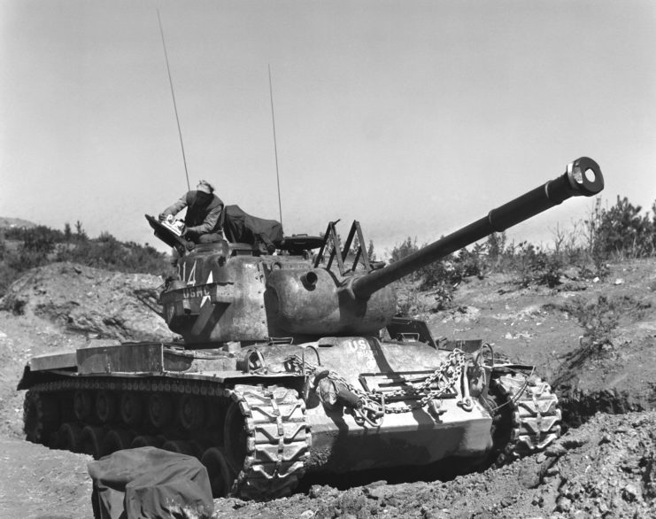 US Marine standing atop an M46 Patton