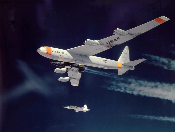 North American X-15 attached to the belly of a Boeing B-52 Stratofortres, with a Northrop T-38 Talon flying underneath