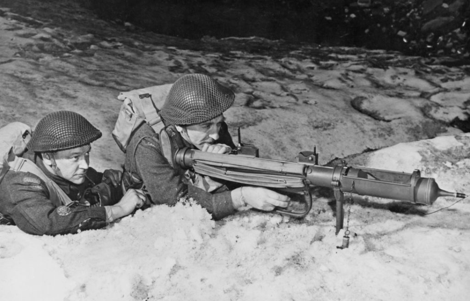Two soldiers lying on the ground while aiming a PIAT