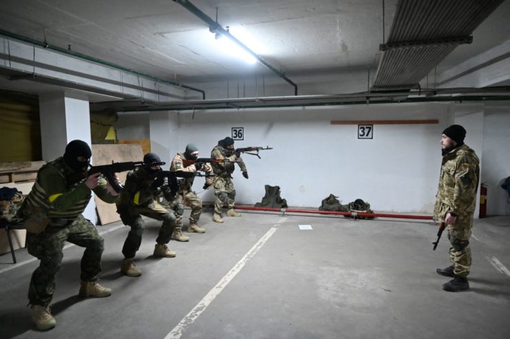 Five members of the Territorial Defence Forces standing in a parking garage