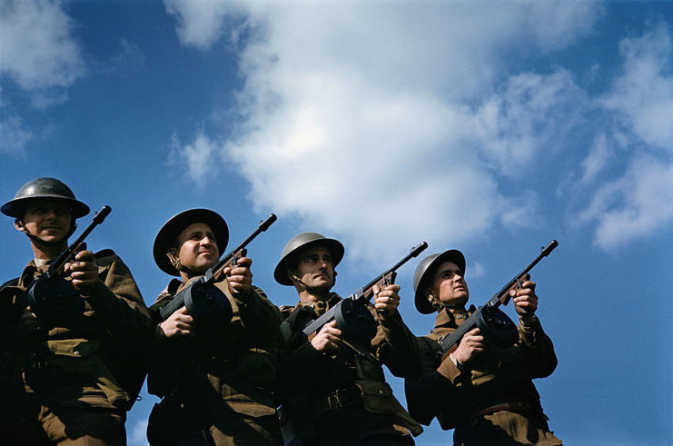 Four British infantrymen aiming Thompson "Tommy Guns"