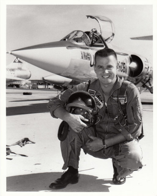 Clarence "Bud" Anderson kneeling in front of a Lockheed F-104 Starfighter