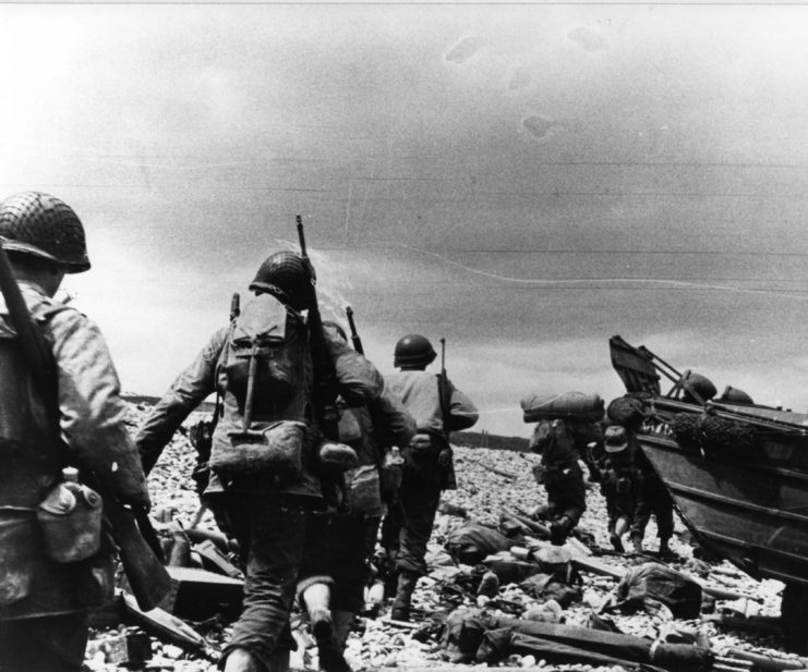 US assault troops running onto a beach