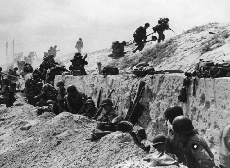 American soldiers climbing over a wall on Utah Beach