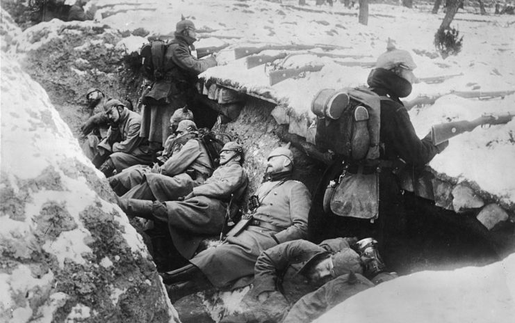 German soldiers sleeping in a trench while two others stand guard