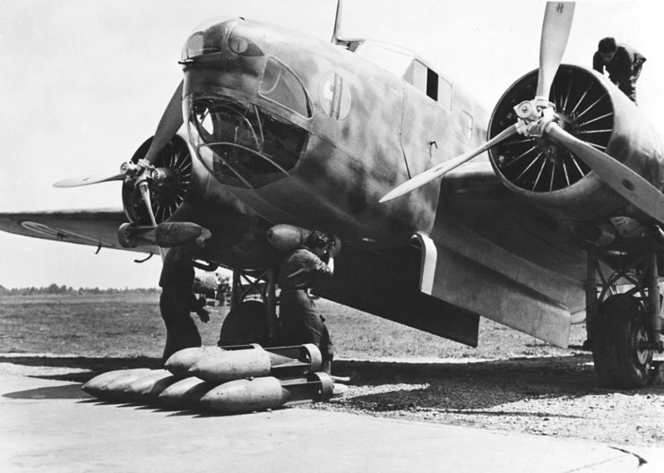 Two ground crew members loading a bomb into the bomb bay of a Fiat BR.20 Cicogna